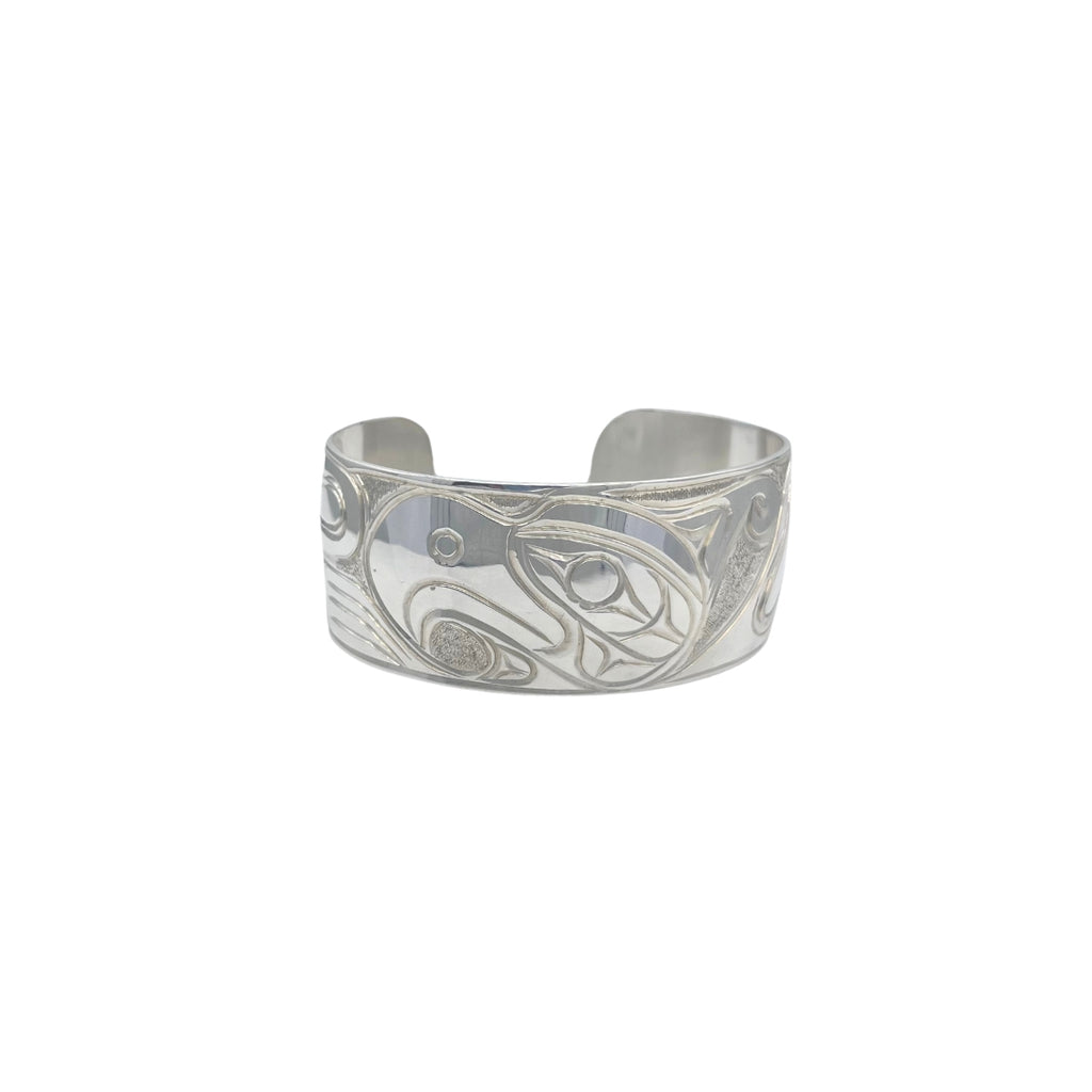 Thunderbird bracelet about a inch thick it is facing left and has a curved bead carved in native formline style