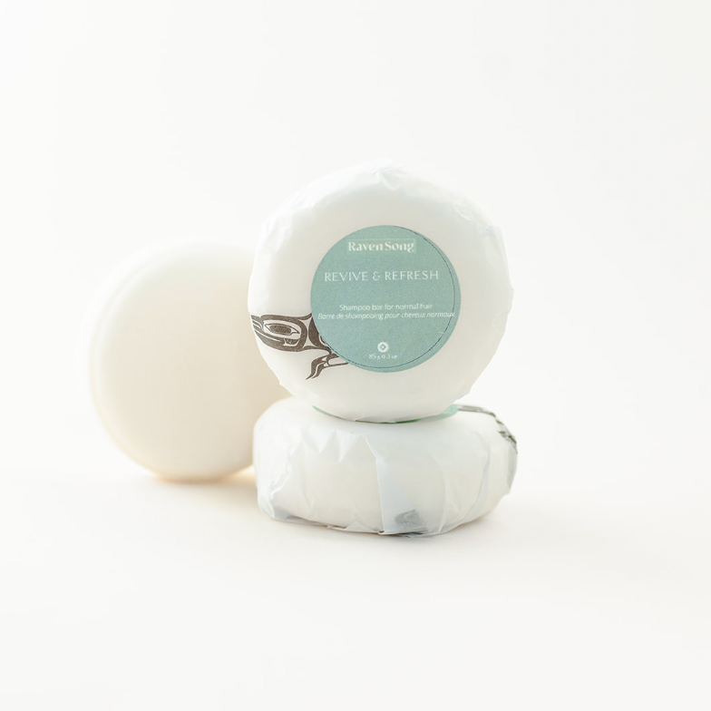 Wrapped soap bars on a white background with a mint green label on one of them.